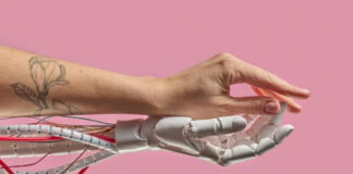 How AI Search Is Reshaping the B2B Buyer Journey A human arm with floral tattoo merges with a white robotic prosthetic hand, symbolizing the integration of human touch and AI in workplace collaboration.