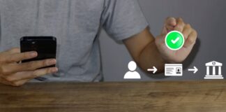 The Role of Blockchain in Verifying Marketing Claims Person holds smartphone displaying digital verification workflow with green checkmark icon, demonstrating blockchain-based authentication systems used to validate marketing claims.