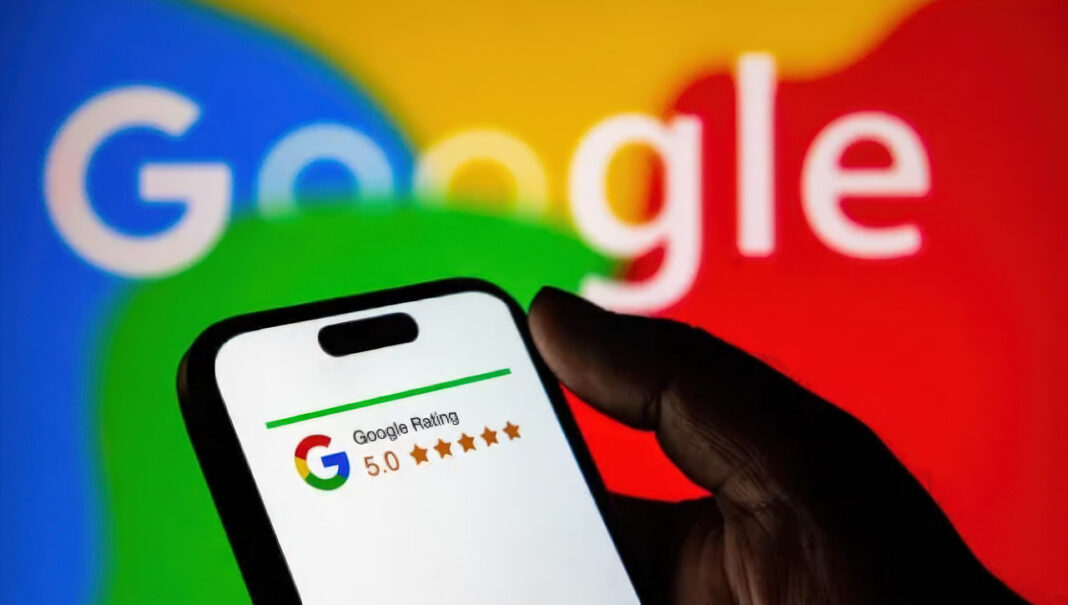 Digital rating interface illustrating trust metrics central to online ad bidding algorithms Hand holding smartphone displaying Google's 5-star rating interface with blurred monitor in background, representing trust score systems used in digital advertising platforms.