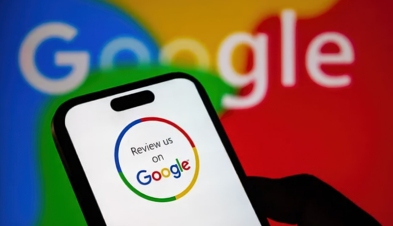 Hand holding smartphone with Google review prompt on screen against blurred Google logo background, representing digital customer engagement and interactive marketing platforms.