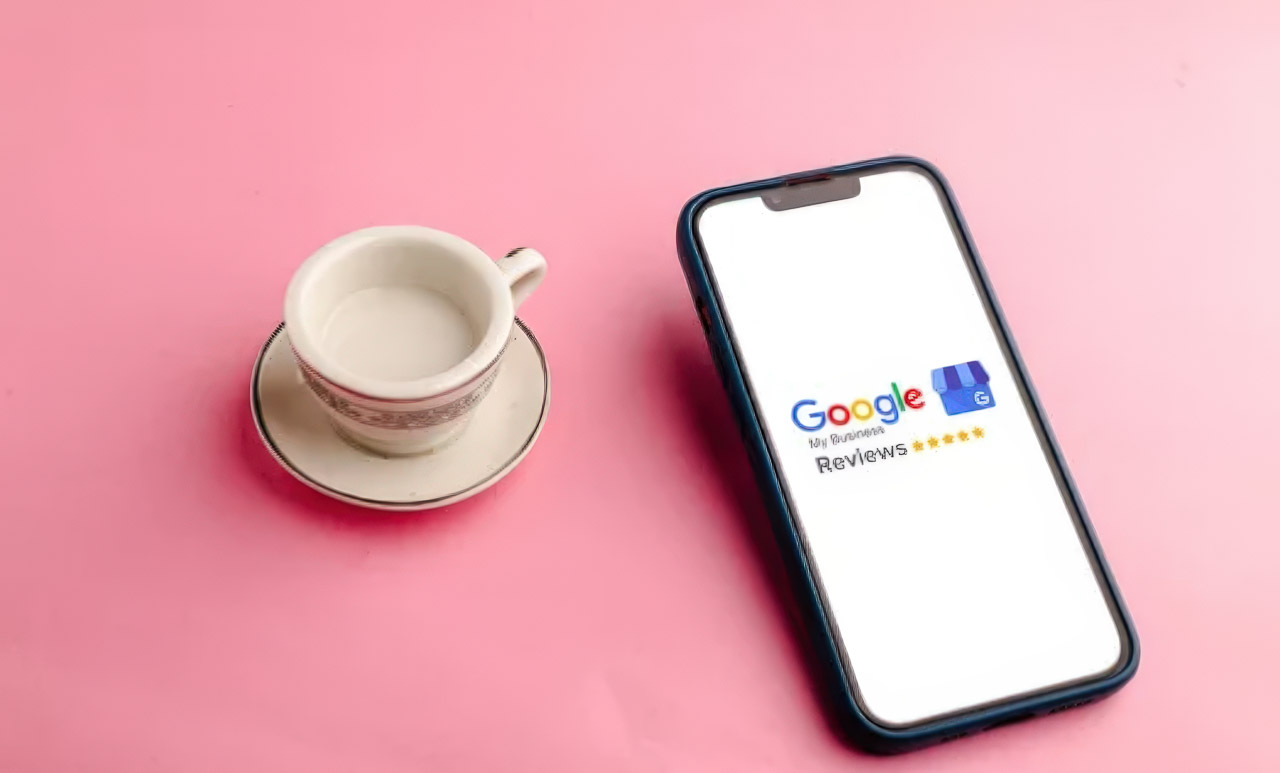 Smartphone screen showing Google Reviews interface with five gold stars next to a white teacup, representing star ratings that appear in search engine results.