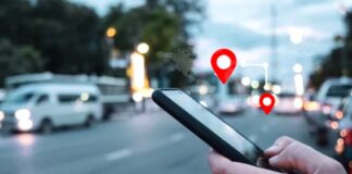 Geofencing and Beacon Tech: The Future of Brick-and-Mortar Ads Hand holding smartphone showing red location pin icons over a blurred city street at dusk, illustrating geofencing technology for retail proximity marketing.