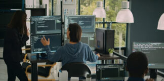How to Fix Your Site’s Biggest Problems Software developers working at multiple monitors displaying code in a modern office workspace, illustrating the collaborative technical process of diagnosing and resolving website issues.