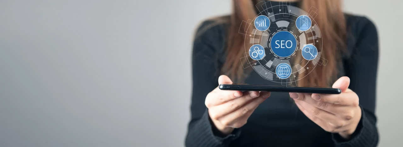 Person holding tablet with holographic SEO interface overlay showing search optimization icons, representing digital tools for maintaining consistent local business listings.
