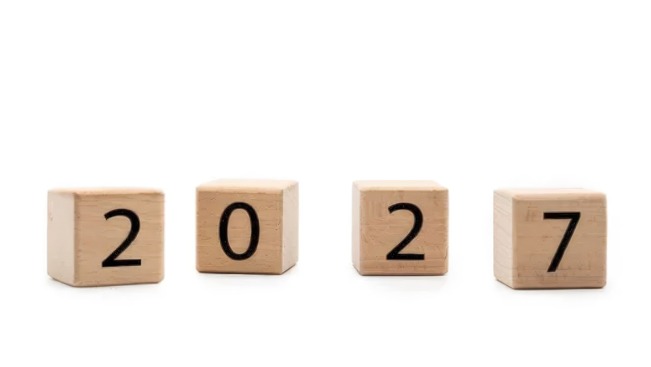 Four wooden blocks with black numerals display 2027 on a white background, representing future planning for business directory evolution.